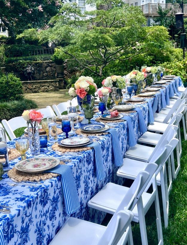 Long outdoor table with blue and white linens